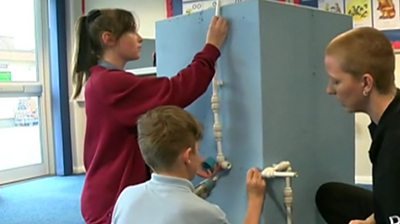 Pupils learning about plumbing.