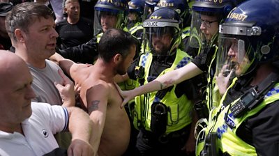 Police pushing back topless protestor