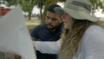 Kola Bokinni and his cousin Mary Ellen look at a map