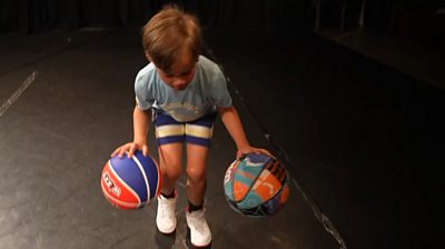 Luther bounces two basketballs