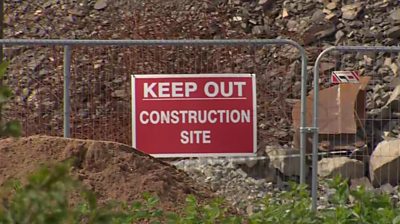 A keep out sign on a fence