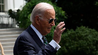 US President Biden waving with sunglasses on