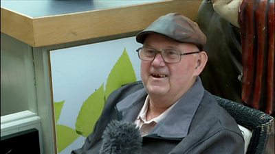 A Newcastle man in flat cap, proudly and happily telling how he uses the local slang.