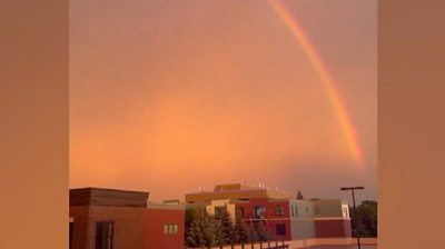 A rainbow in an orange sky