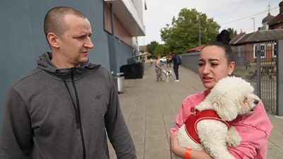 Lukasz and Agnieszka, holding dog