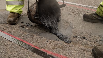 A pothole being repaired