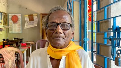 Kanailal Hait, an elderly Indian man who survived the 1943 Bengal famine, wearing a white kurta and yellow scarf