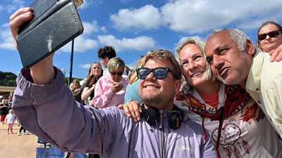 James Corden poses for selfies with fans at Barry Island