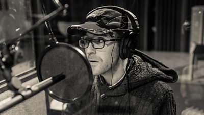 Actor recording a part with a microphone in a studio