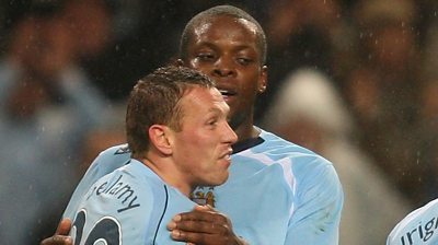 Craig Bellamy of Manchester City is congratulated by Nedum Onuoha while playing for Manchester City in 2009