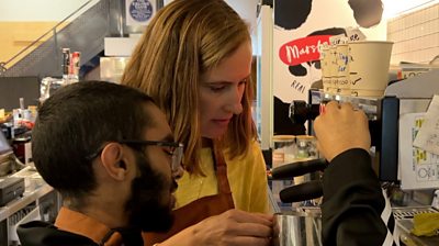 Muriel showing Ibraheem how to make a coffee