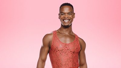 Headshot of Johannes Radebe in front of Strictly Come Dancing branding for 2024.