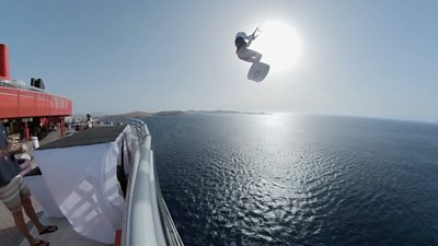 Kitesurfer Tom Bridge leaps from a cruise ship