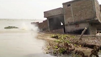 Two-story building collapses into flooded river