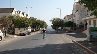 Paul Adams stands in a deserted street