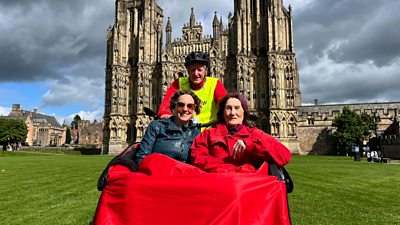 Wells Community Network's trishaw in front of Wells Cathedral.