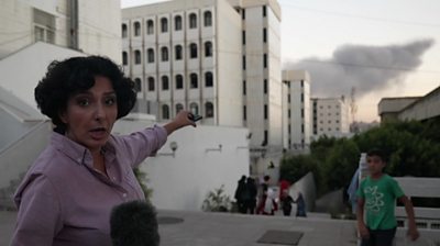 BBC World Service correspondent, Nafiseh Kohnavard pointing at smoke above Beirut