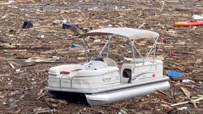 Boat surrounded by debris