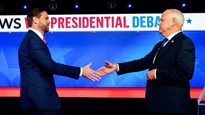 JD Vance and Tim Walz approach to shake hands on stage following debate