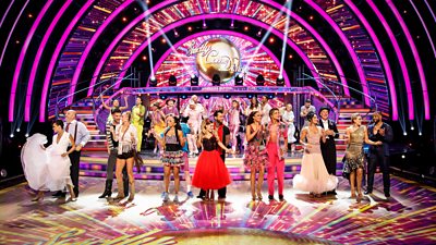 The Strictly Come Dancing celebrities and their pro partners stand on the ballroom floor in costume