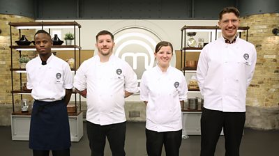 Four MasterChef contestants Nkosi, Toby, Chloe, Gaston stand in the Masterchef kitchen smiling wearing MasterChef branded shirts