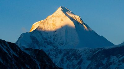 the Dhaulagiri, a huge snowy mountain, peak catching the first morning light