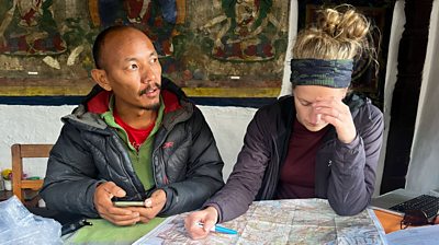 Man and woman looking at a map deep in thought