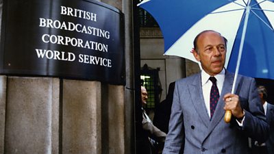 John Tusa seen in the late 1980s, outside Bush House the former ý World Service headquarters in London with an umbrella. 