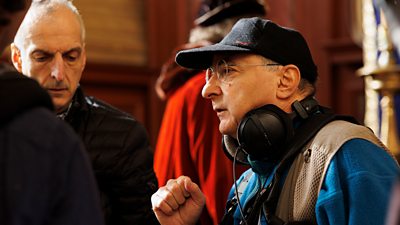 Director, Peter Kosminsky speaking with crew and cast on the set of Wolf Hall: The Mirror and the Light 