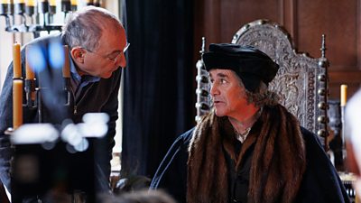 Behind-the-scenes image from Wolf Hall: The Mirror and the Light. Director, Peter Kosminsky chats with Mark Rylance during filming. 