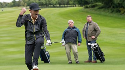 Rod (Stuart Bowman) celebrating on a golf course with his fist in the air.  Ken and Richard Pritchard (Gregor Fisher and Greg McHugh) slightly blurred in the background looking on