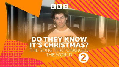 Composite image of Bob Geldof showing the t-shirt he's wearing that says "Feed the World". Orange and pink Radio 2 graphics round the edge. 'Do They Know It’s Christmas?: The Song That Changed The World' in white text