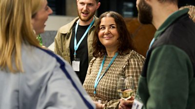 Local Democracy Reporters chat in a small group and share a drink ahead of the awards ceremony