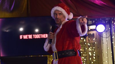 Marcus Brigstocke sings karaoke, dressed as Santa Claus