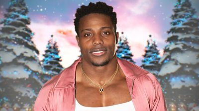 Harry Aikines-Aryeetey wears a pink shirt over a white vest top and is pictured against a backdrop of snowy animated Christmas trees