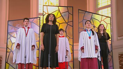 five young people singing in a church