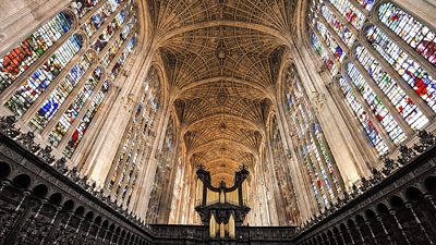 Interior of the chapel of King's College with a grand ceiling and stain glass windows