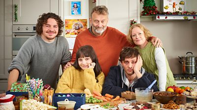 Ben (Daniel Roche), Karen (Ramona Marquez), Dad (Hugh Dennis), Jake (Tyger Drew Honey) and Mum (Claire Skinner) pose in a very messy Christmassy kitchen