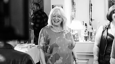 A black and white image of a woman laughing on the set of Gavin & Stacey