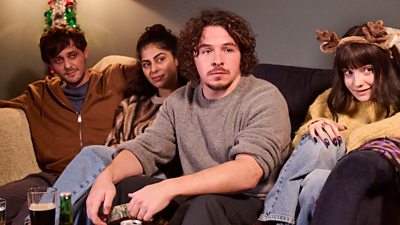 Jake (Tyger Drew Honey), Rani (Kerena Jagpal), Ben (Daniel Roche) and Karen (Ramona Marquez) sit on a sofa together looking to something off screen