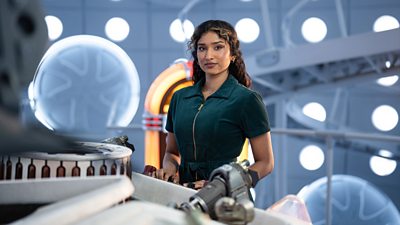 Belinda stands by the TARDIS console