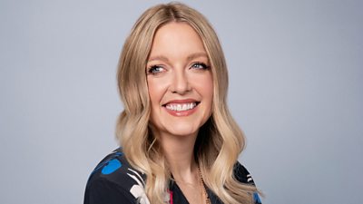 A head and shoulders shot of Lauren Laverne, smiling, against a grey background