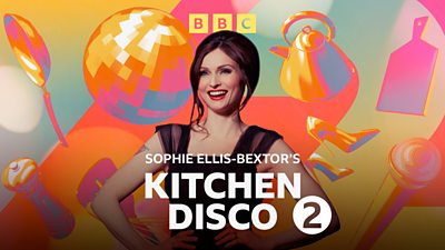 Sophie stood with her hands on her hips smiling.  She wears a dark purple party dress and behind her there are drawn images of microphones, glitter balls and kitchen utensils such as a ketle