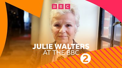 Julie Walters smiling at the camera surrounded by Radio 2's pink and orange colour patterns