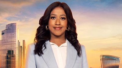 Anisa wears a light blue linen blazer with a white blouse and a gold hoop earrings. Her curled hair drapes over each shoulder. A backdrop of the London skyline at sunset 