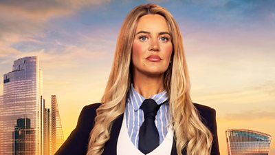 Aoibheann wears a striped shirt and navy tie with a white waistcoat and navy blazer. her long blonde hair curls at the end. A backdrop of the London skyline at sunset 