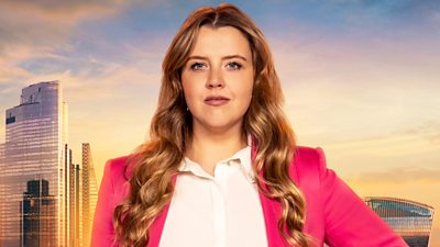 Emma wears a hot pink blazer with an open collared white shirt underneath. Her long golden curled hair drapes over each shoulder. A backdrop of the London skyline at sunset 