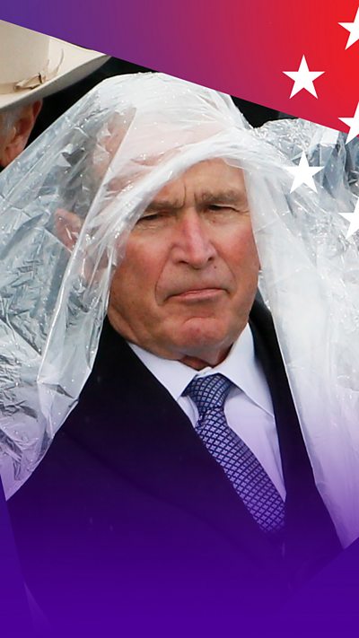 George W. Bush wearing a plastic poncho over his head