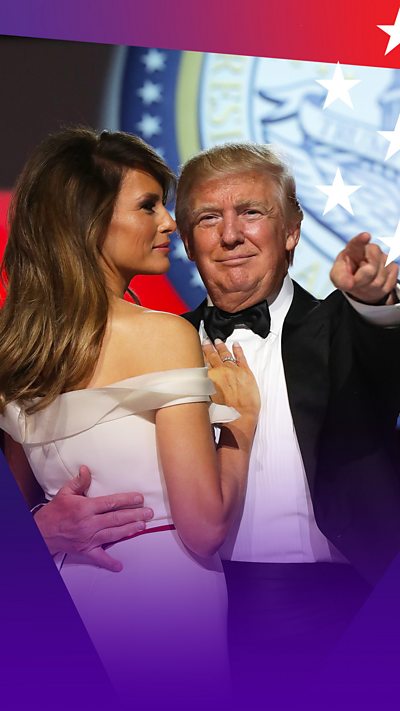 Melania Trump wearing a white dress dancing with Donald in a black bow tie as he points into the crowd