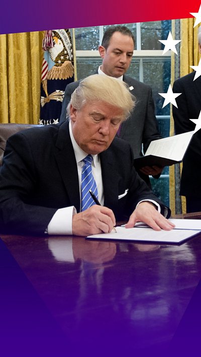 Donald Trump in the Oval Office signing an executive order days after his inauguration in 2017